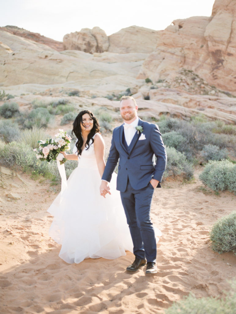 Bride and Groom walking hand in hand - Valley of Fire